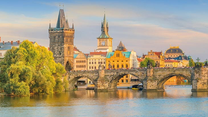 The Charles Bridge over the Vltava River in Prague at sunset